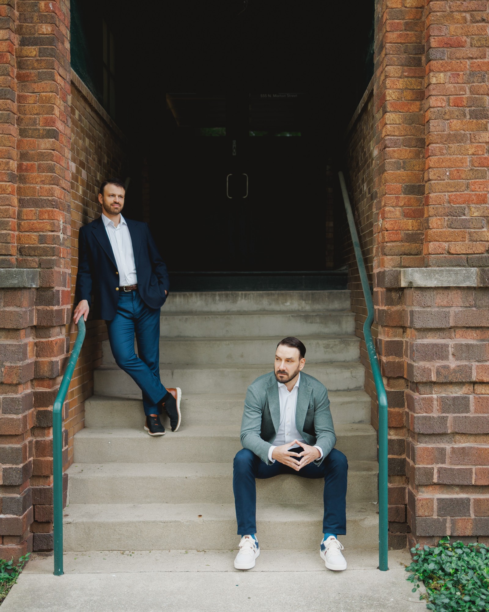 Lance daSilva and Mason Greenberg on brick building steps