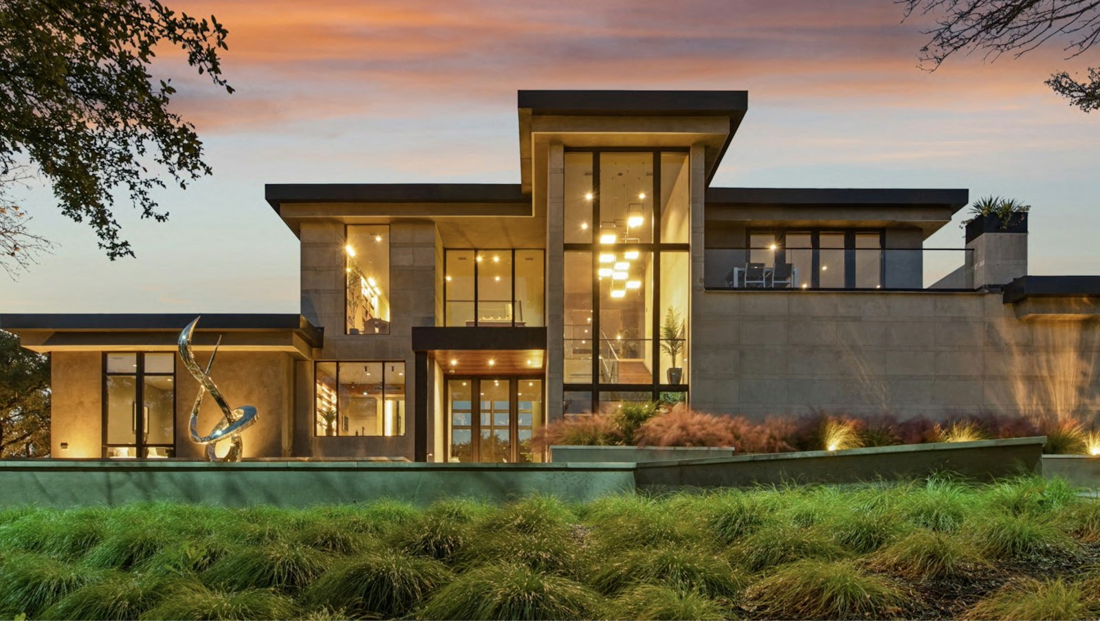Modern luxury home with large windows at dusk